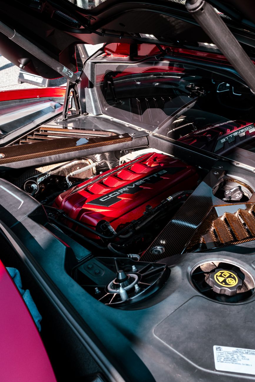 Close-up of a car engine in bright daylight