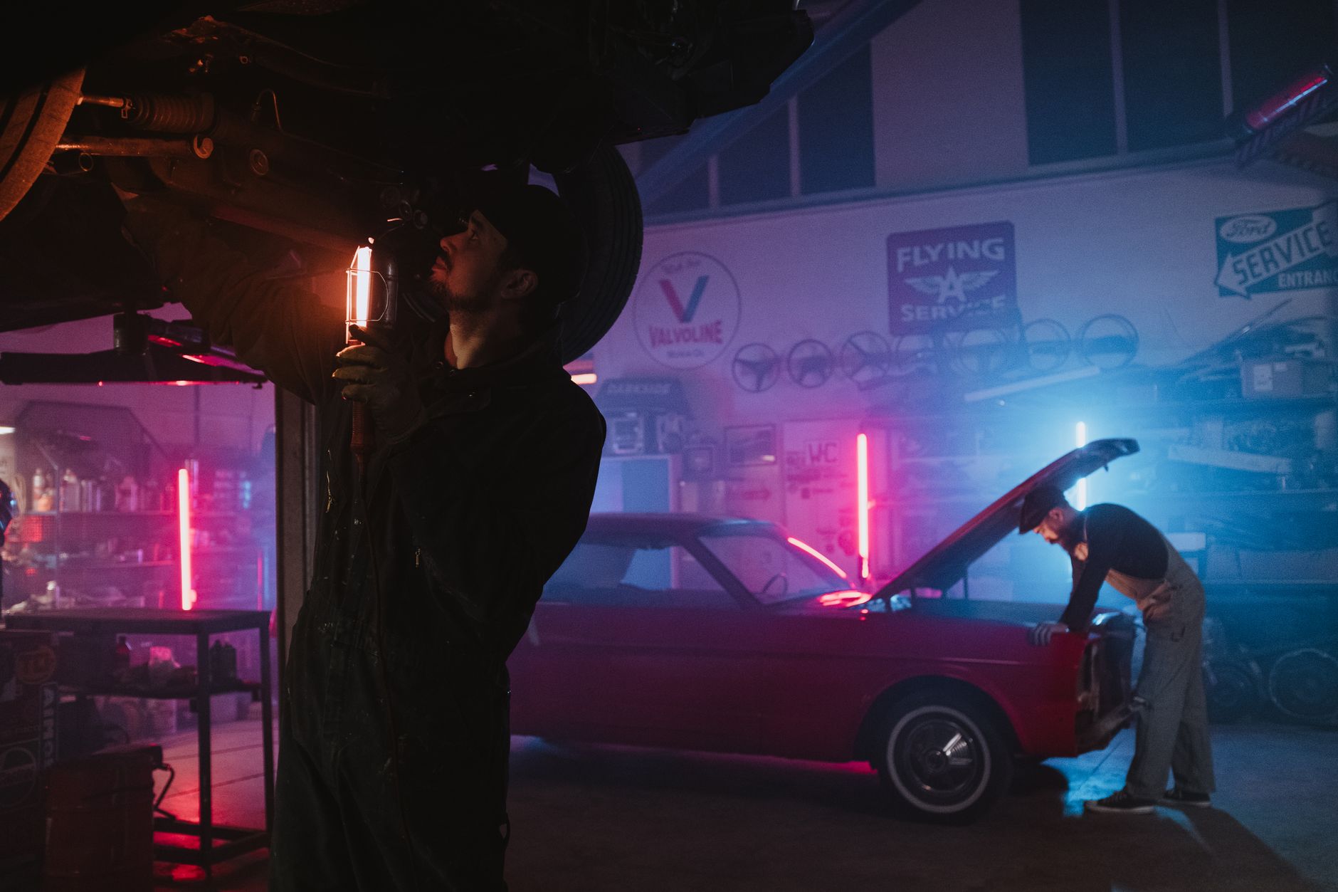 Mechanics working on a car in a garage